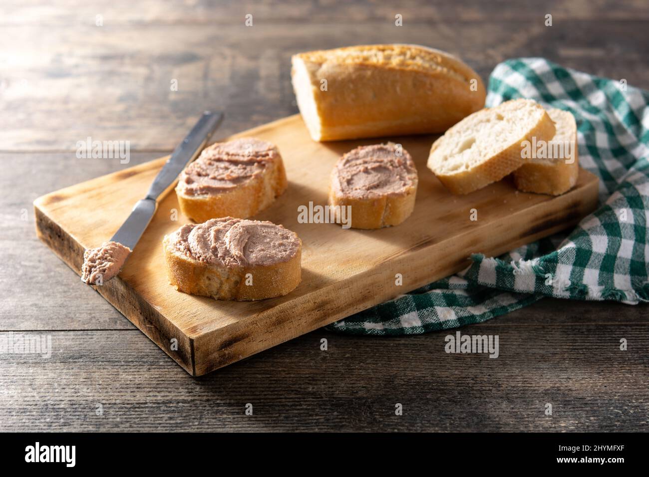 Geröstetes Brot mit Schweineleber-Pastete auf Holztisch Stockfoto