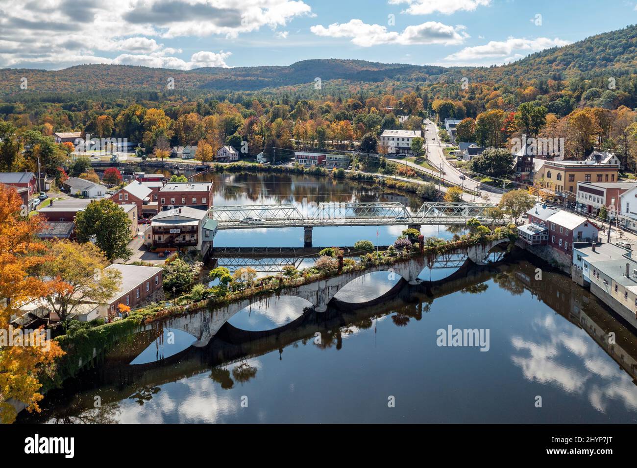 Die Bridge of Flowers überspannt den Deerfield River mit den sanften Hügeln des westlichen Massachusetts als Kulisse in Shelburne, MA im Herbst. Stockfoto