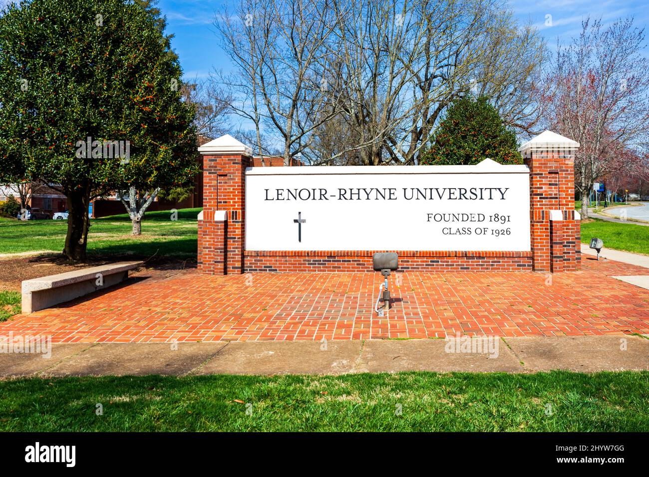 HICKORY, NC, USA-8. MÄRZ 2022: Denkmal-Schild der Lenoir-Rhyne University mit Campus dahinter. Stockfoto