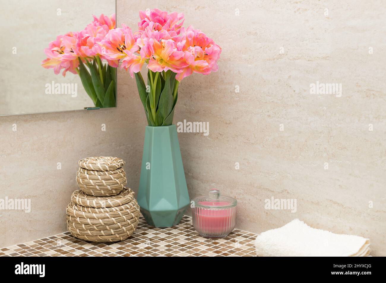 Mosaik-Bad Arbeitsplatte mit schönen Tulpenblüten, Korb und Handtuch Stockfoto