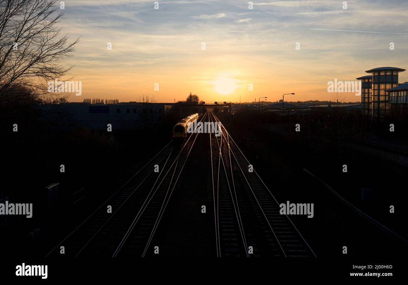 East Midlands Züge der Klasse 222 Merdian Train 222018 auf der midland-Hauptlinie in Nottingham mit Zug und Schienen, die in der untergehenden Sonne glitzern Stockfoto