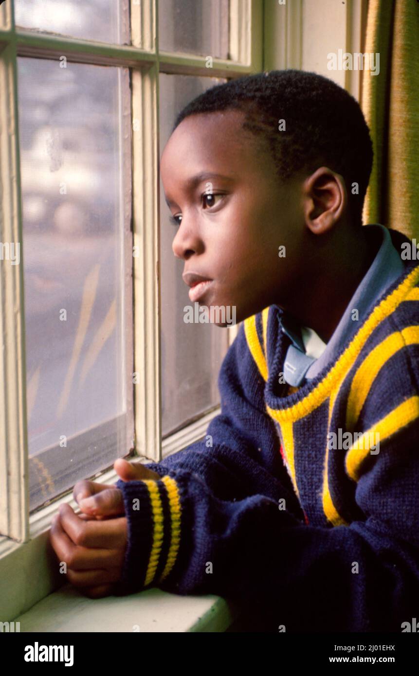 New Jersey T-Shirt, schwarzer Junge Kind Kind Fenster suchen Denken verloren gedacht, Stockfoto