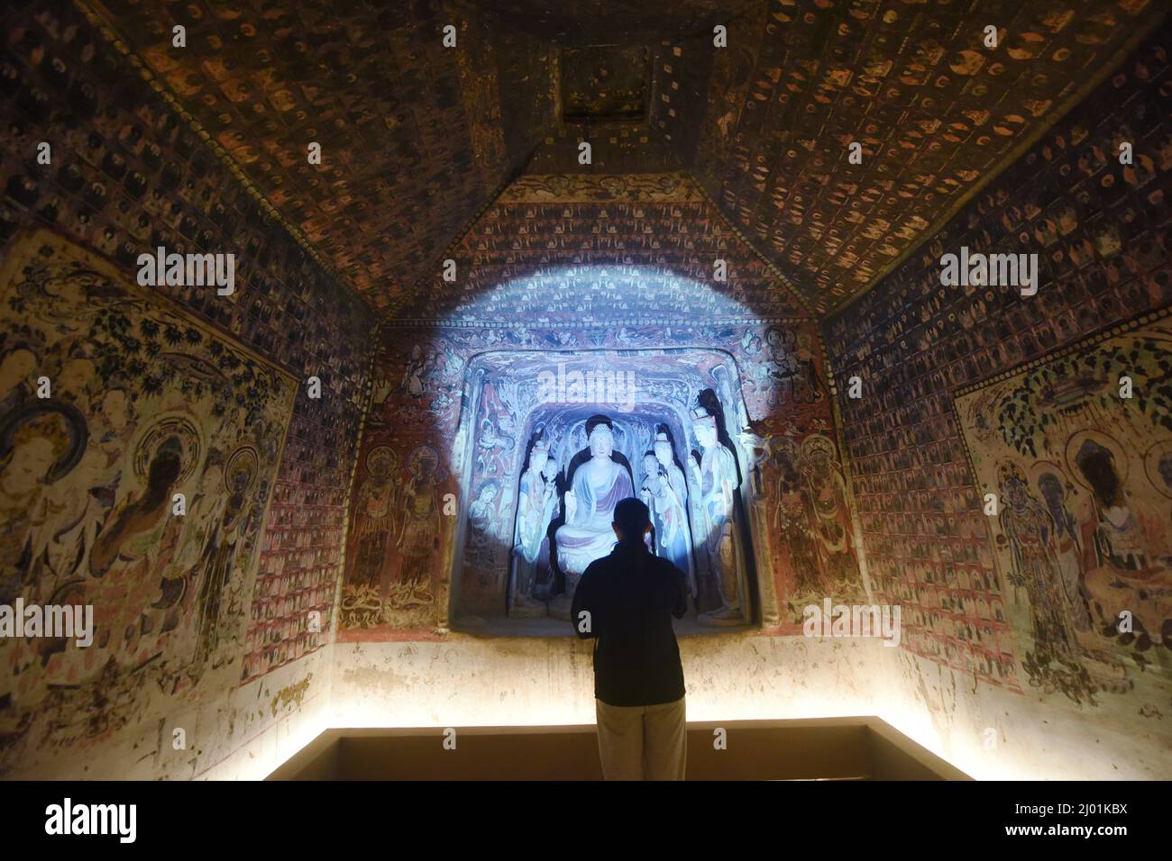 HANGZHOU, CHINA - 16. MÄRZ 2022 - Besucher sehen sich die 3D gedruckte Restaurierung der Höhle 45 der Dunhuang Mogao Grotten (tang Dynastie) im Zhejiang Art Museu an Stockfoto