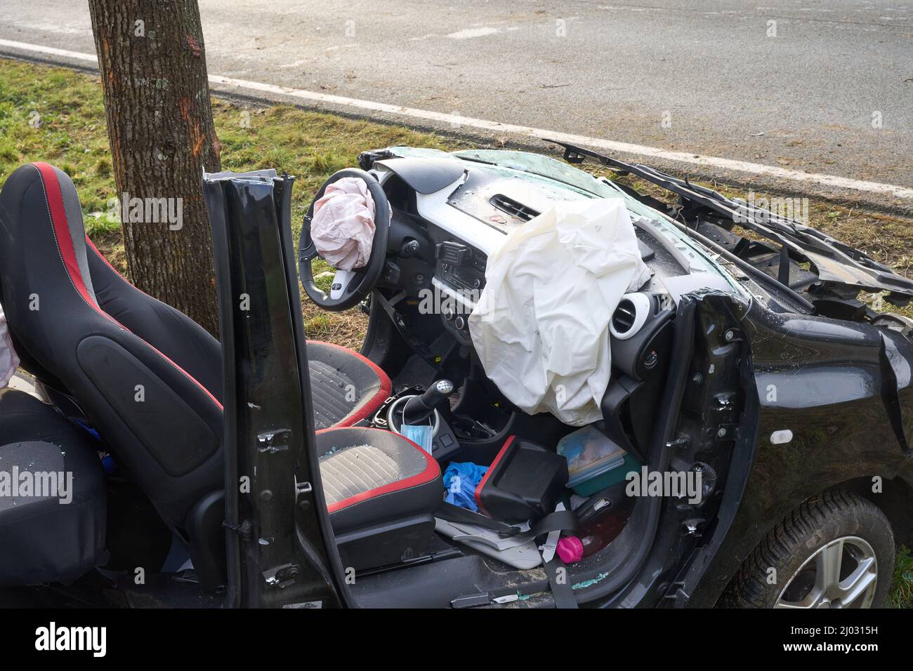 Fachbach, Deutschland. 16. März 2022. Das Wrack eines Pkw steht auf der Bundesstraße 260 gegen einen Baum. Die 29-jährige Fahrerin verlor bei einem Überholmanöver die Kontrolle über ihr Fahrzeug und stürzte in einen Baum. Sie starb am Unfallort. Quelle: Thomas Frey/dpa/Alamy Live News Stockfoto