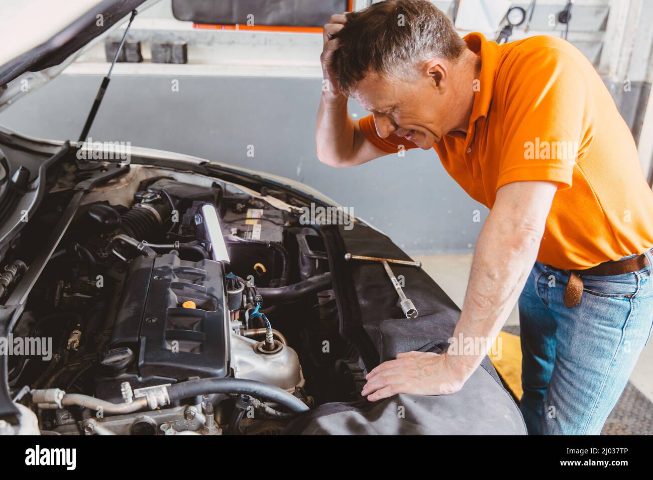 Garagenmechaniker Arbeiter Stress mit Problem Auto Motor ausfallen Stockfoto