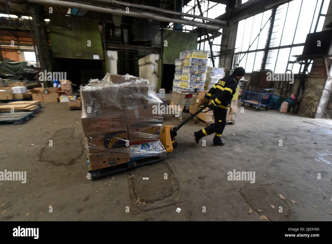 Ostrava, Tschechische Republik. 16. März 2022. Dutzende von Paletten humanitärer Hilfe wurden am 16. März 2022 von Feuerwehrleuten in einem Sammelzentrum in Ostrava, Tschechien, verladen. Über das Tschechische Rote Kreuz wird ein großer Teil dieser materiellen Hilfe direkt an Bedürftige in die Ukraine gehen und ein Teil wird für Flüchtlinge verwendet werden, die in die Tschechische Republik gegangen sind. Kredit: Jaroslav Ozana/CTK Foto/Alamy Live Nachrichten Stockfoto