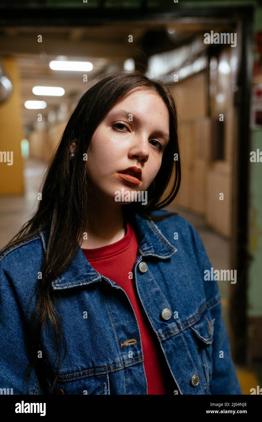 Frau im Denim-Hemd, die in der Mitte des Korridors steht Stockfoto