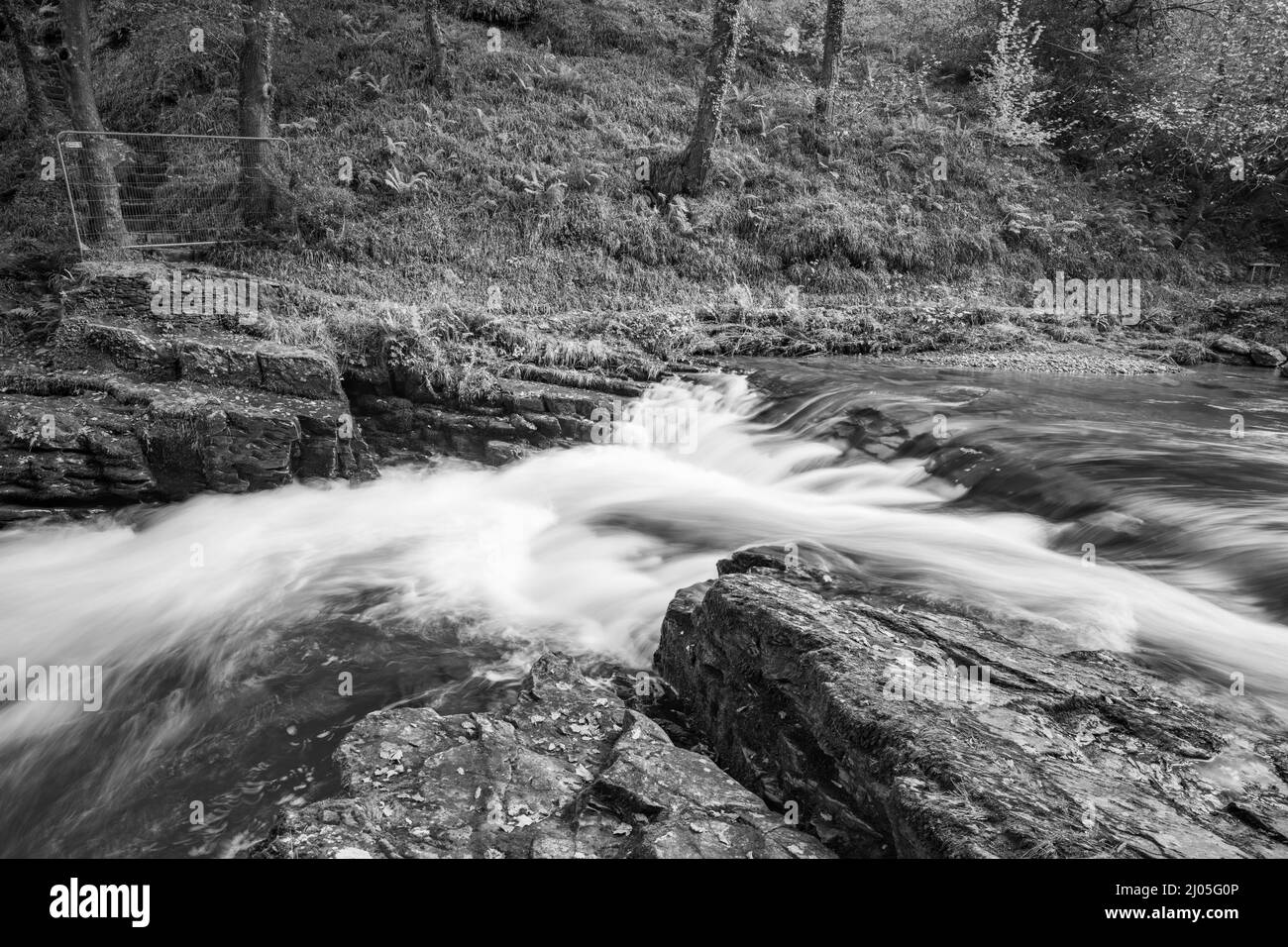 Langzeitbelichtung des Wassersmeet Bridge Wasserfalls am East Lyn Fluss bei Watersmeet im Exmoor National Park Stockfoto