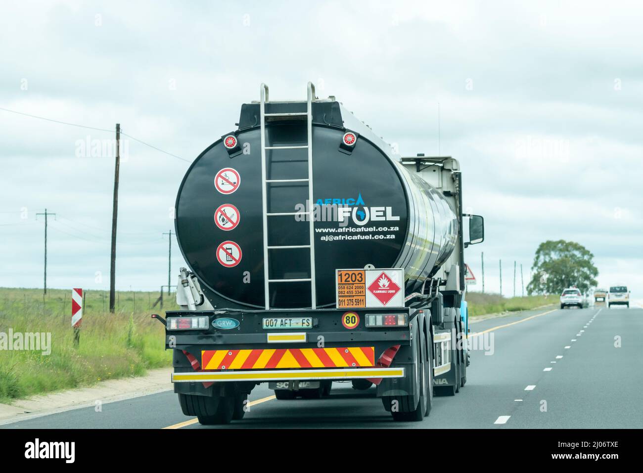 Kraftstoff- oder Benzintanker in Nahaufnahme auf einer Straße in einem ländlichen Gebiet Südafrikas, auf der ein Aufkleber mit der Brennstoffindustrie für brennbare Flüssigkeiten auf der Rückseite angebracht ist Stockfoto