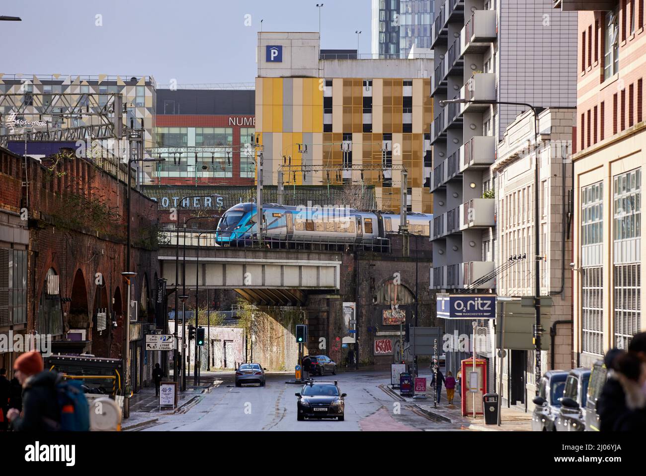 Street Scene Whitworth Street Manchester, TPE Zug erhöhten Strecke durch das Stadtzentrum Stockfoto