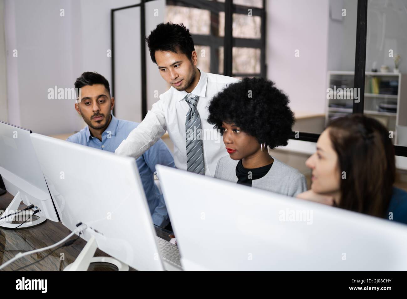 Gruppe von Happy Business Menschen mit Laptop diskutieren am Arbeitsplatz im Büro Stockfoto