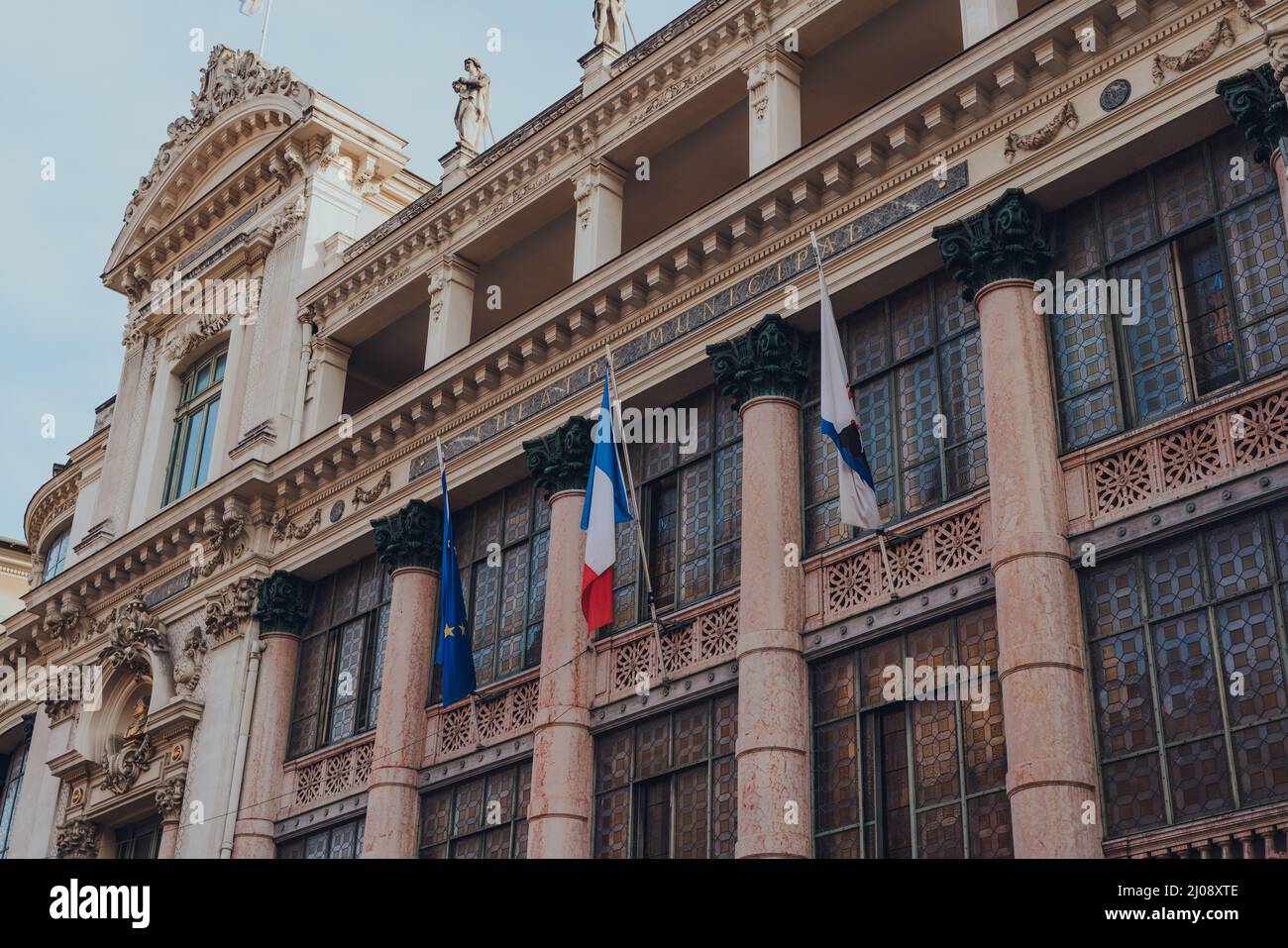 Nizza, Frankreich - 10. März 2022: Flaggen an der Vorderseite der Opera de Nice, dem wichtigsten Opernhaus in Nizza, in dem das Ballett Mediterrannee und das Th untergebracht sind Stockfoto