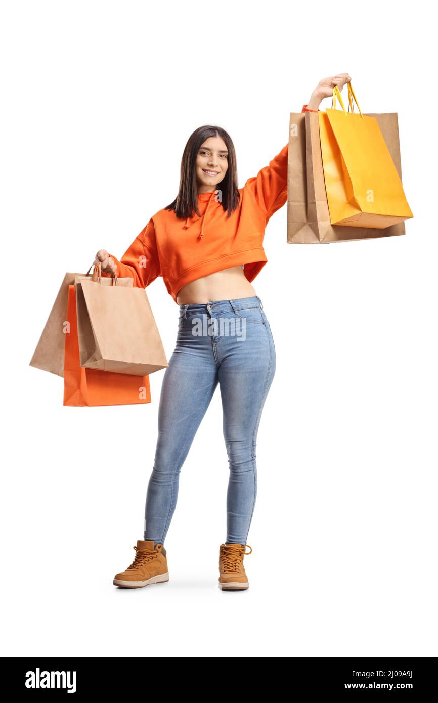 In voller Länge Porträt einer jungen glücklichen Frau hält Einkaufstaschen isoliert auf weißem Hintergrund Stockfoto