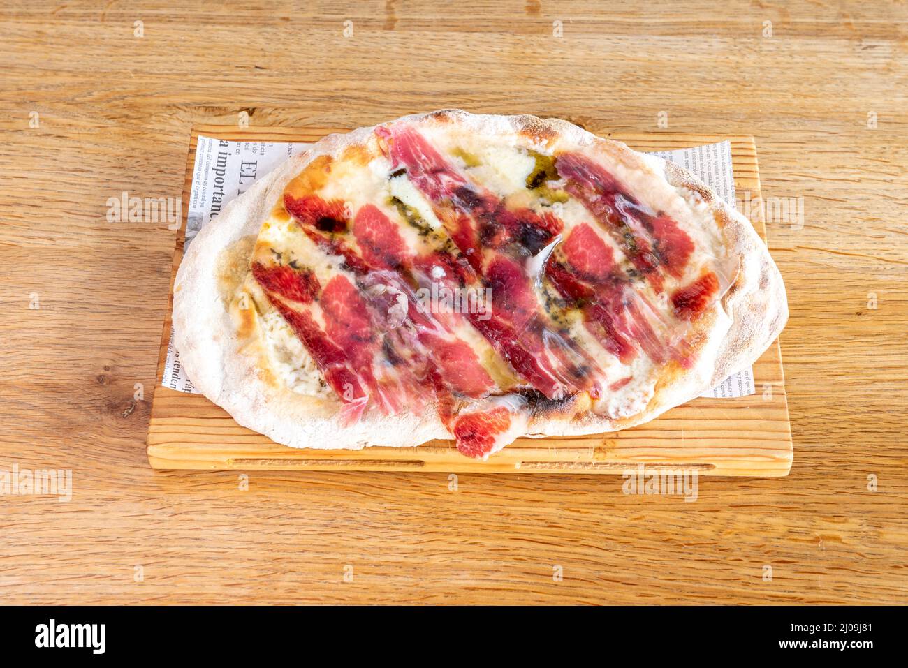 Rustikale Pizza mit doppelten Pepperoni und Mozzarella-Käse, serrano-Schinken und Cheddar Stockfoto