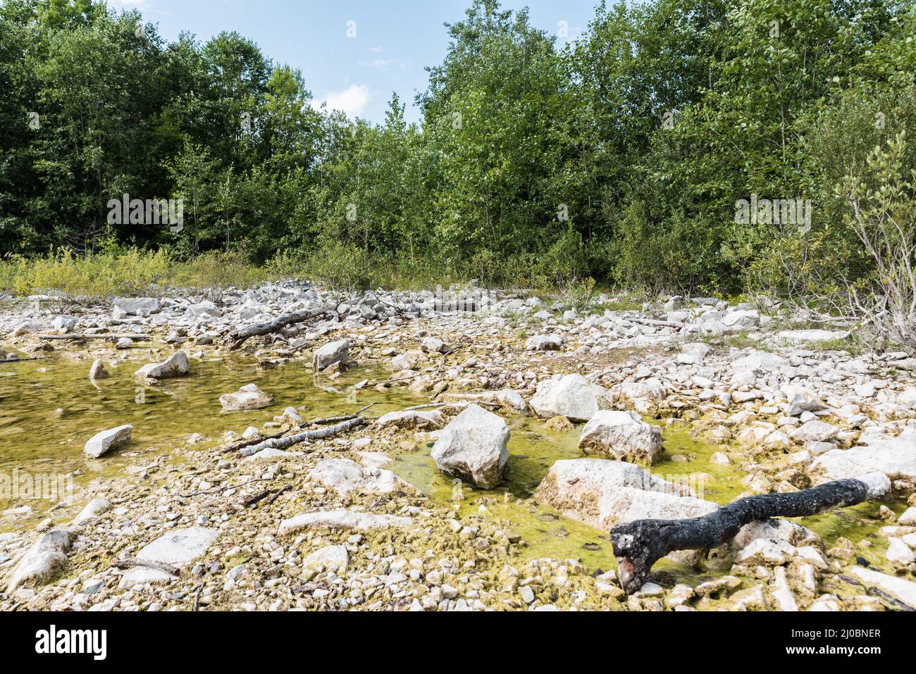 Panoramablick über den kleinen See und die natürliche Umgebung mit einem Strand und Wäldern rund um die Sala Silvergruva, die Sala Silver Mine, Schweden Stockfoto