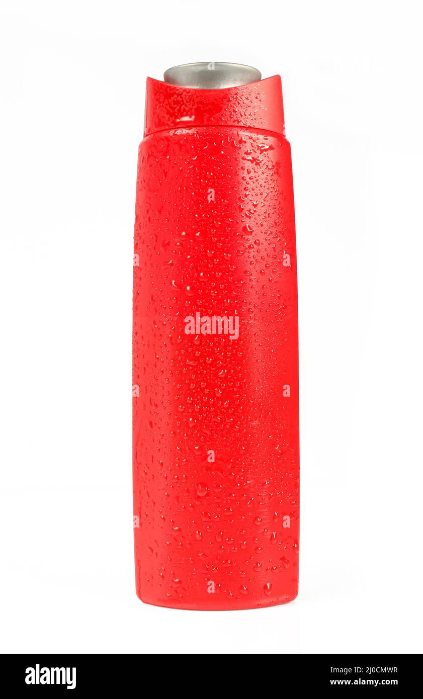 Nasse rote Shampoo-Flasche isoliert auf weißem Hintergrund. Glänzende Wassertropfen auf dem Behälter mit Kunststoffflüssigkeit Stockfoto