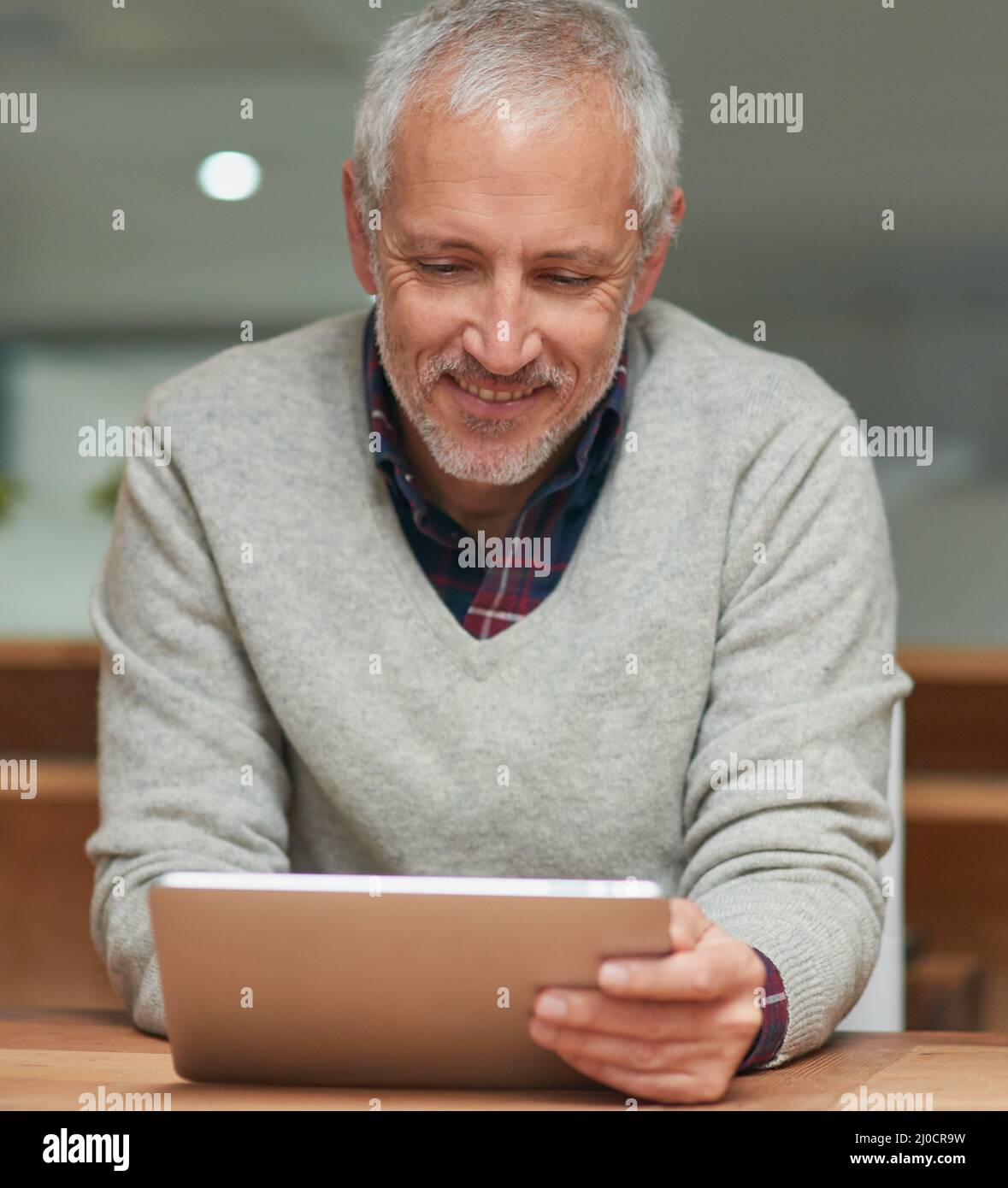 Seinen digitalen Workflow überarbeiten. Aufnahme eines reifen Geschäftsmannes, der ein digitales Tablet verwendet, während er im Büro arbeitet. Stockfoto