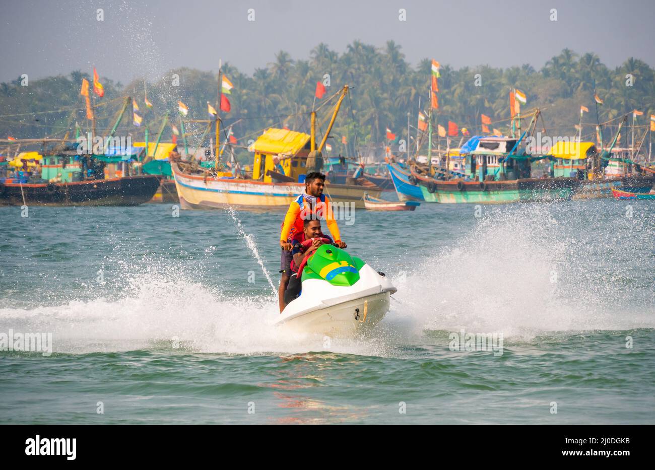 Malvan, INDIEN - 23. Dezember 2021 : nicht identifizierter Tourist, der eine Jet-Ski-Fahrt am Strand von Tarkarli genießt. Der Strand ist berühmt für verschiedene Wassersportarten Stockfoto