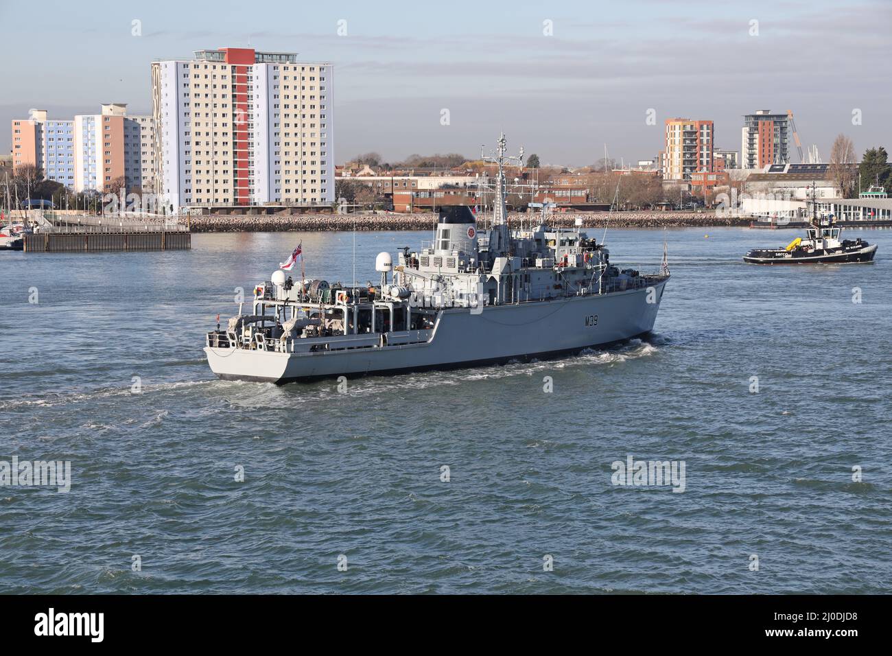 Der Schlepper SD SUZANNE vor dem Minenzähler der Royal Navy Hunt Class misst Schiff HMS HURWORTH beim Einlaufen in den Hafen Stockfoto