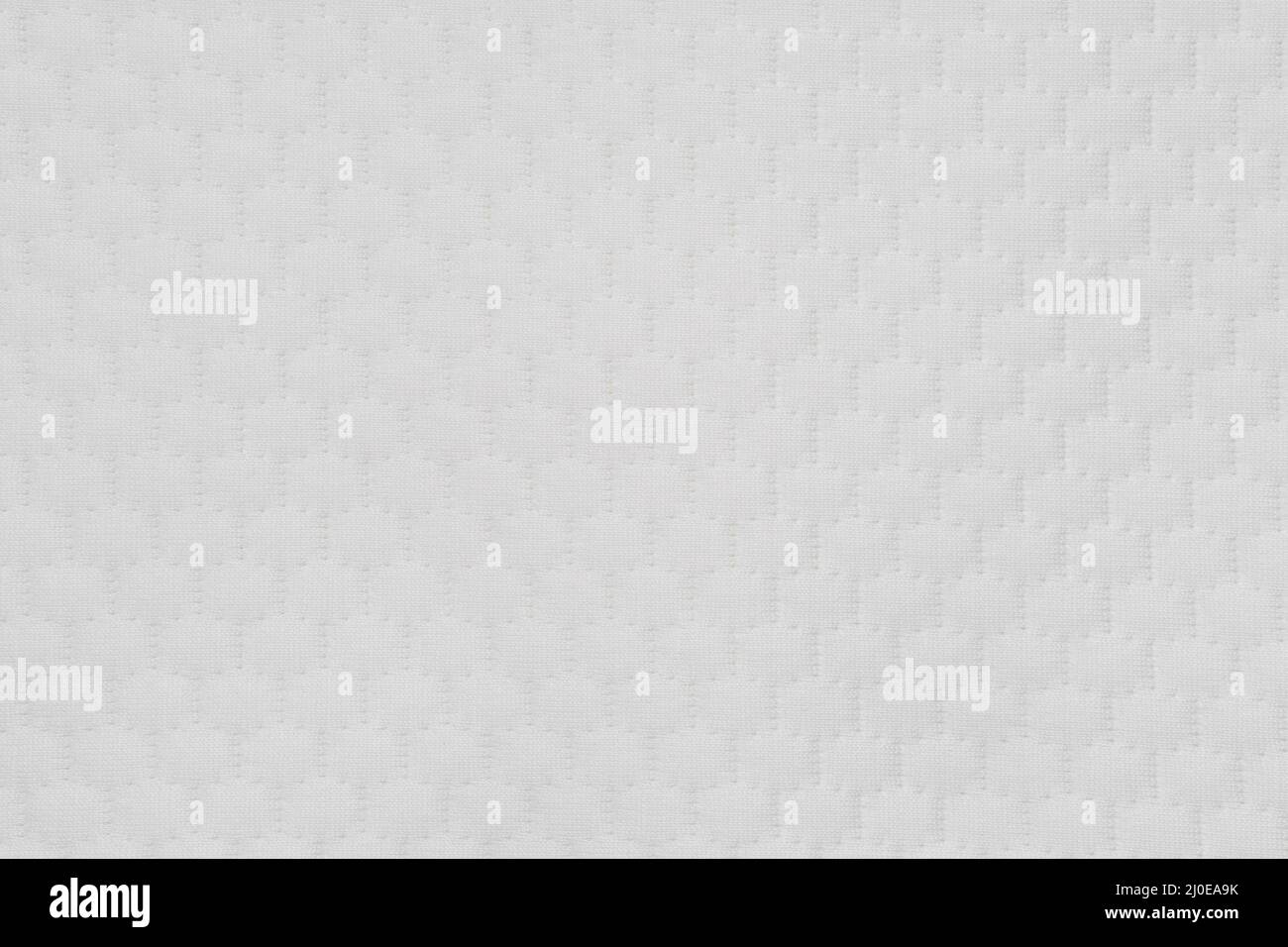 Weiße Matratzenauflage. Gesteppte Kissenstruktur. Matratzenauflage im Hintergrund. Stockfoto