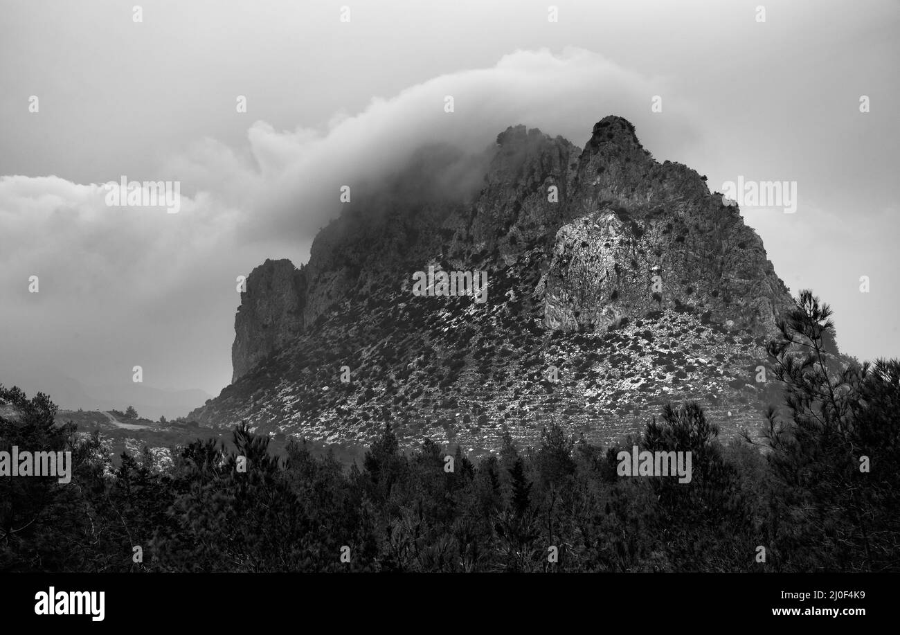 Berggipfel mit dramatischen Wolken bedeckt Stockfoto