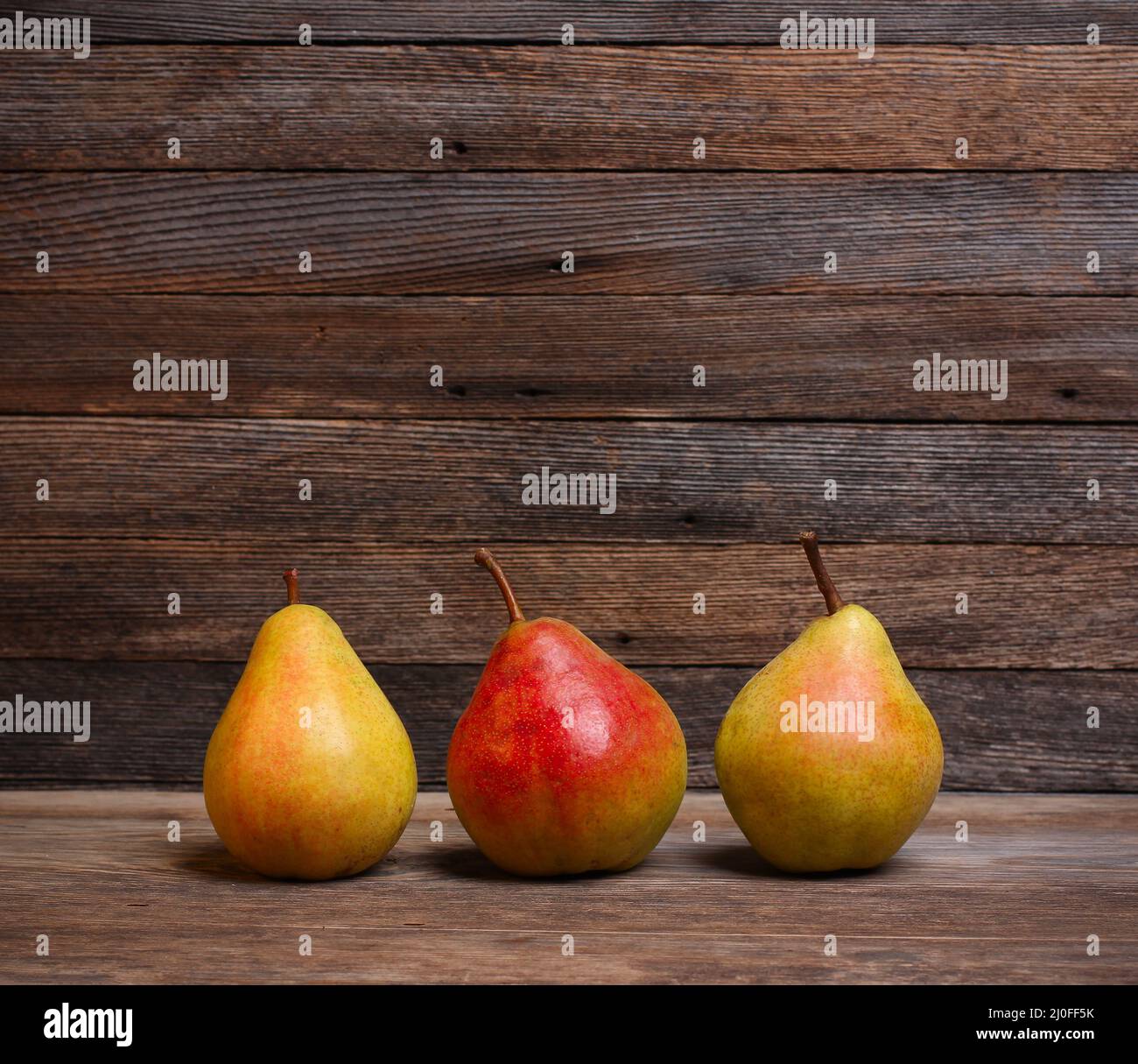 Drei reife süße Birnen auf einem alten Holz-Retro-Hintergrund mit Platz für Text Stockfoto