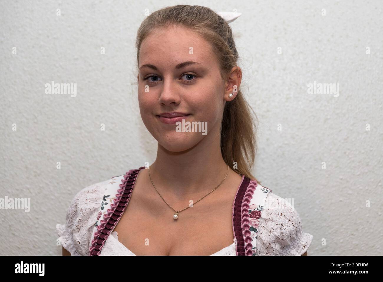 Porträt von ziemlich lächelndes Mädchen in Dirndl-Kleid und Halskette Stockfoto