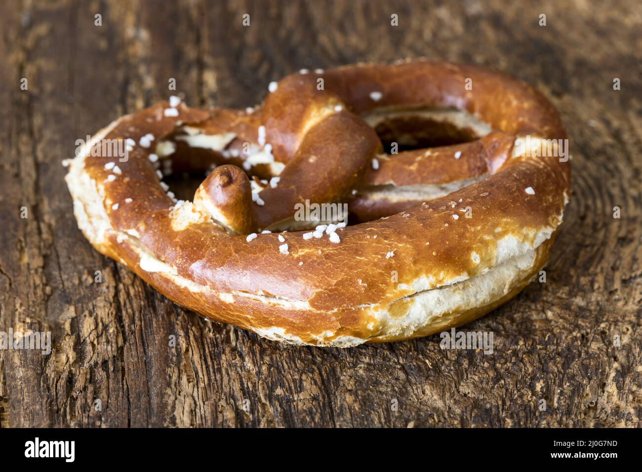 Bayerische Butterbrezel auf dunklem Holz Stockfoto