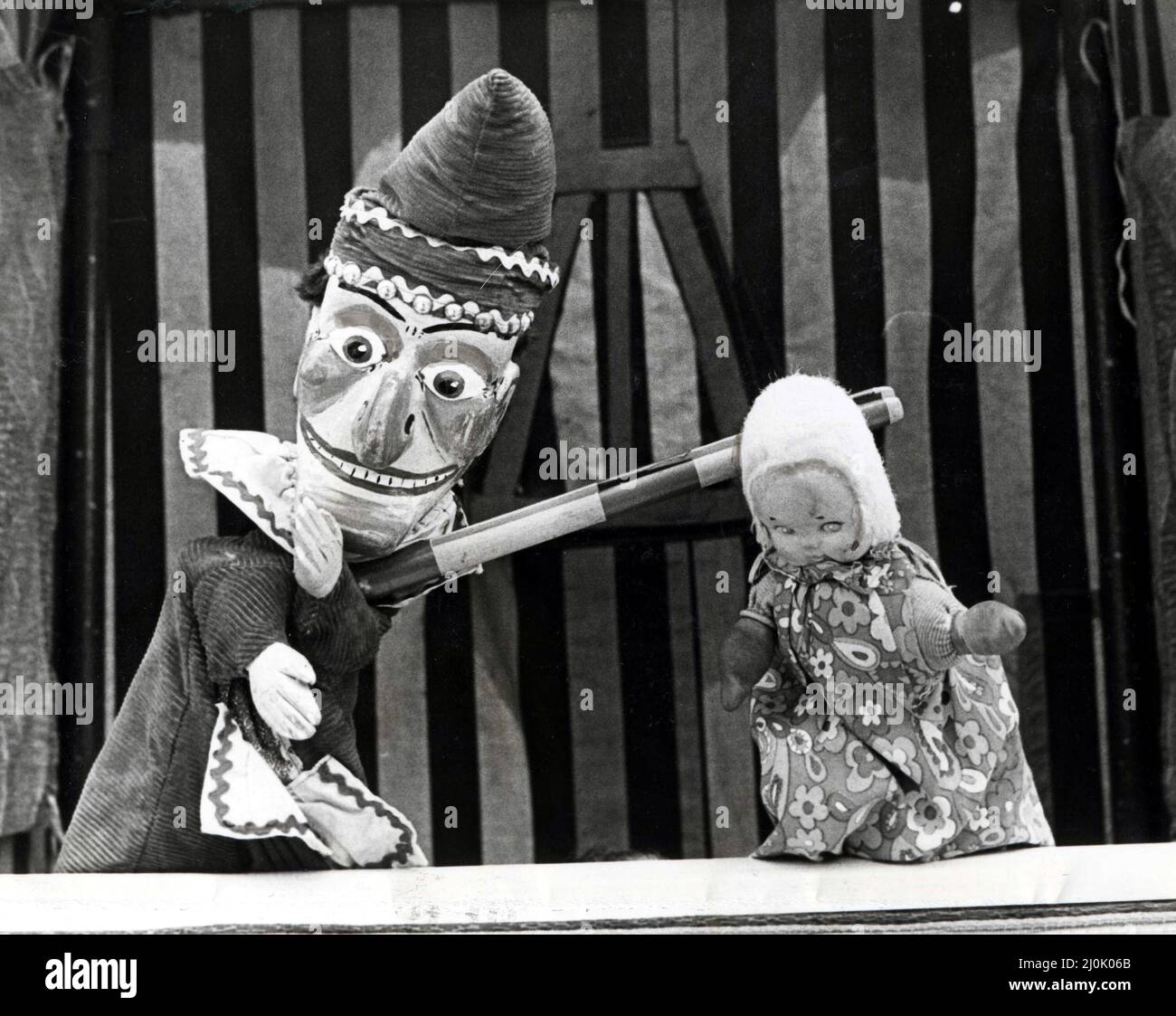 Punch und Judy - „so geht's!“ Herr Punch (links) zeigt Cardfif Childminders und ihren Anschuldigungen, was nicht zu tun ist, wenn Sie das Baby in der Hand haben. Die Cardiff Childminders Association veranstaltete heute (Mi) ein Picknick für das Kind im Victoria Park, Cardiff. 17.. Juni 1981. Stockfoto