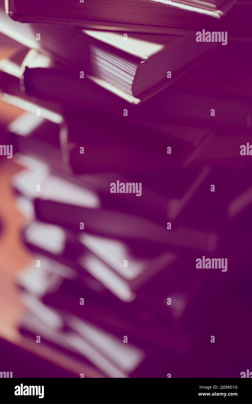 Bücherstapel in Bibliothek. Wissenschaftliche, pädagogische und fiktionale Papierbücher. Aus- und Weiterbildung. Stockfoto