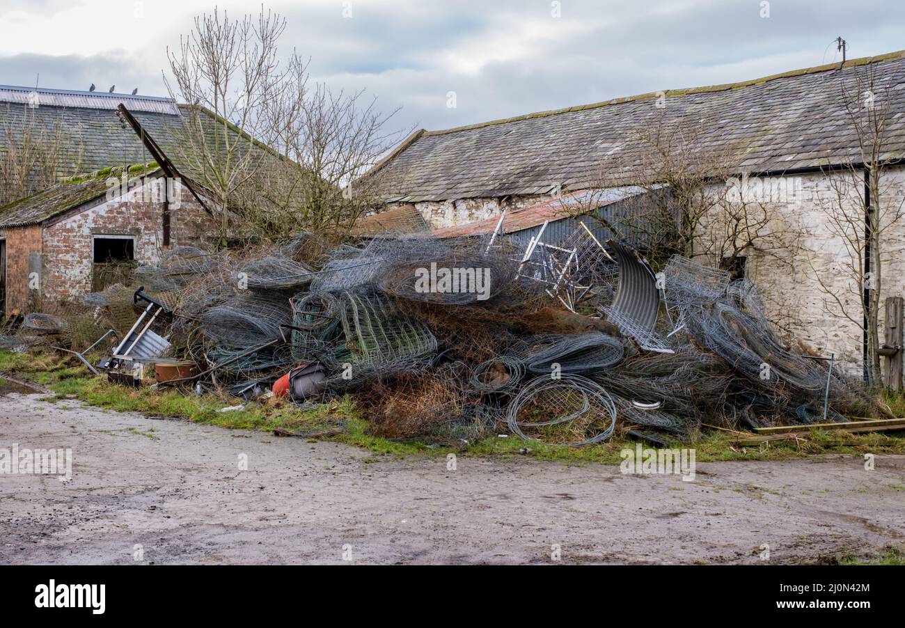 Haufen rostiger Metallzäune stapelten sich als landwirtschaftlicher Abfall Stockfoto