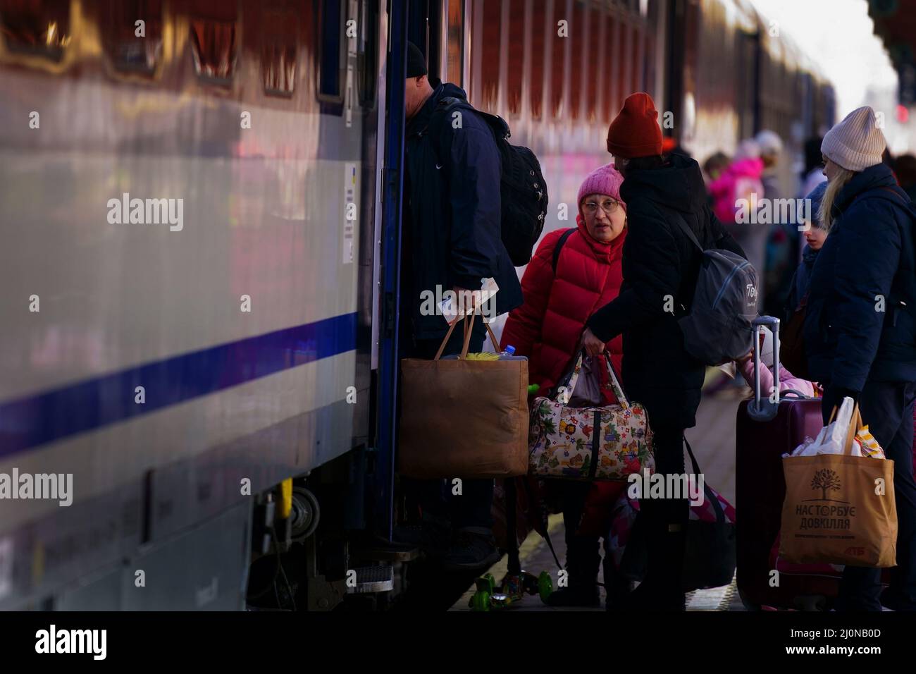 Familien aus der Ukraine steigen mit ihrem Gepäck auf einem Bahnsteig am polnischen Bahnhof Przemysl in einen Zug nach Breslau ein. Bilddatum: Samstag, 19. März 2022. Stockfoto