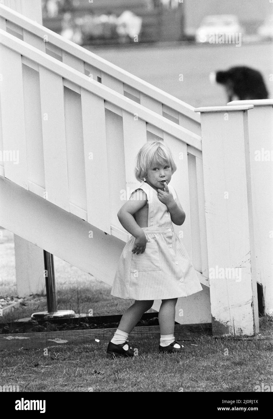 Die dreijährige Zara Phillips, Tochter von Prinzessin Anne und Kapitän Mark Phillips, nahm am Polospiel auf dem Smith's Lawn Polo Ground in Windsor Teil. Hier ist sie abgebildet, wie sie Peekaboo über dem königlichen Zaun spielt. 17.. Juni 1984. Stockfoto