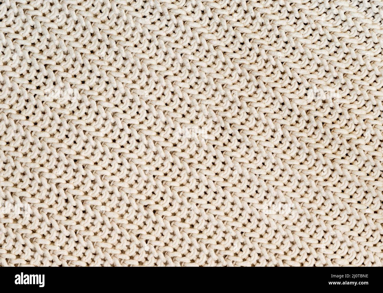 Hintergrund der handgefertigten gestrickten Stoff aus Baumwolle White Cream Farbe, Stoff gestrickt Textur. Stockfoto
