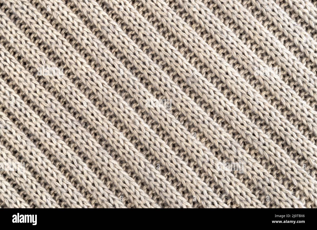 Hintergrund der handgefertigten Strickstoff aus Wolle Creme Farbe, Stoff gestrickt Textur. Stockfoto