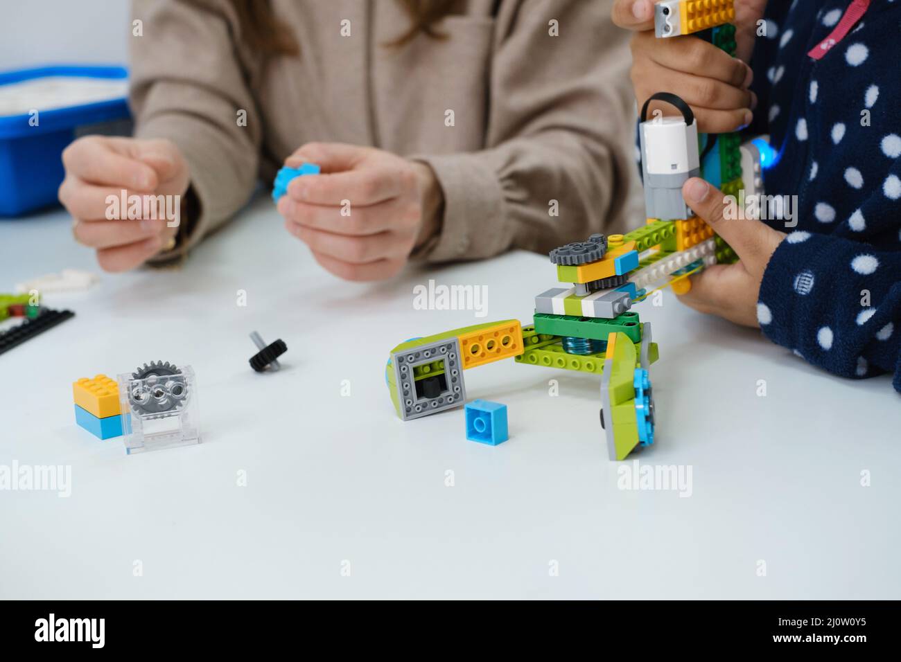 Multiethnische Kinder am MINT-Unterricht Roboter im Klassenzimmer mit Lehrerin bauen Kinder machen elektronisches Armmodell an der modernen Wissenschaftsschule Stockfoto