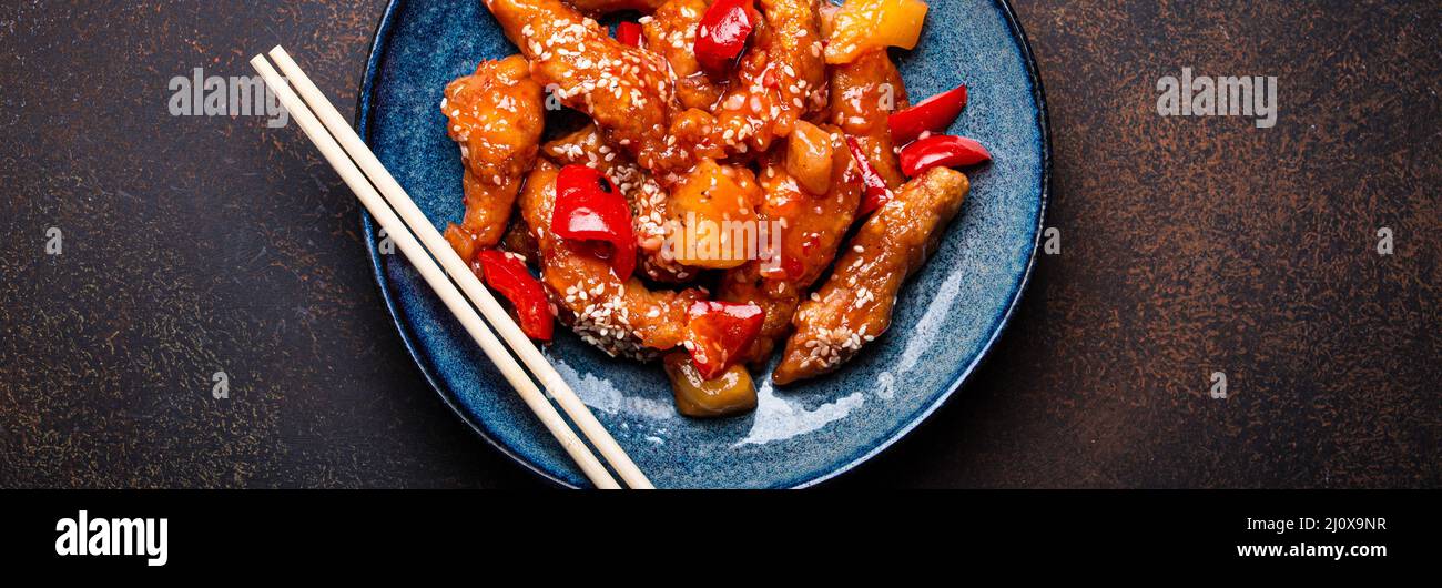 Chinesische traditionelle Wok-Gericht Schweiß-und saure frittierte Huhn mit Gemüse rühren-braten auf dem Teller Stockfoto