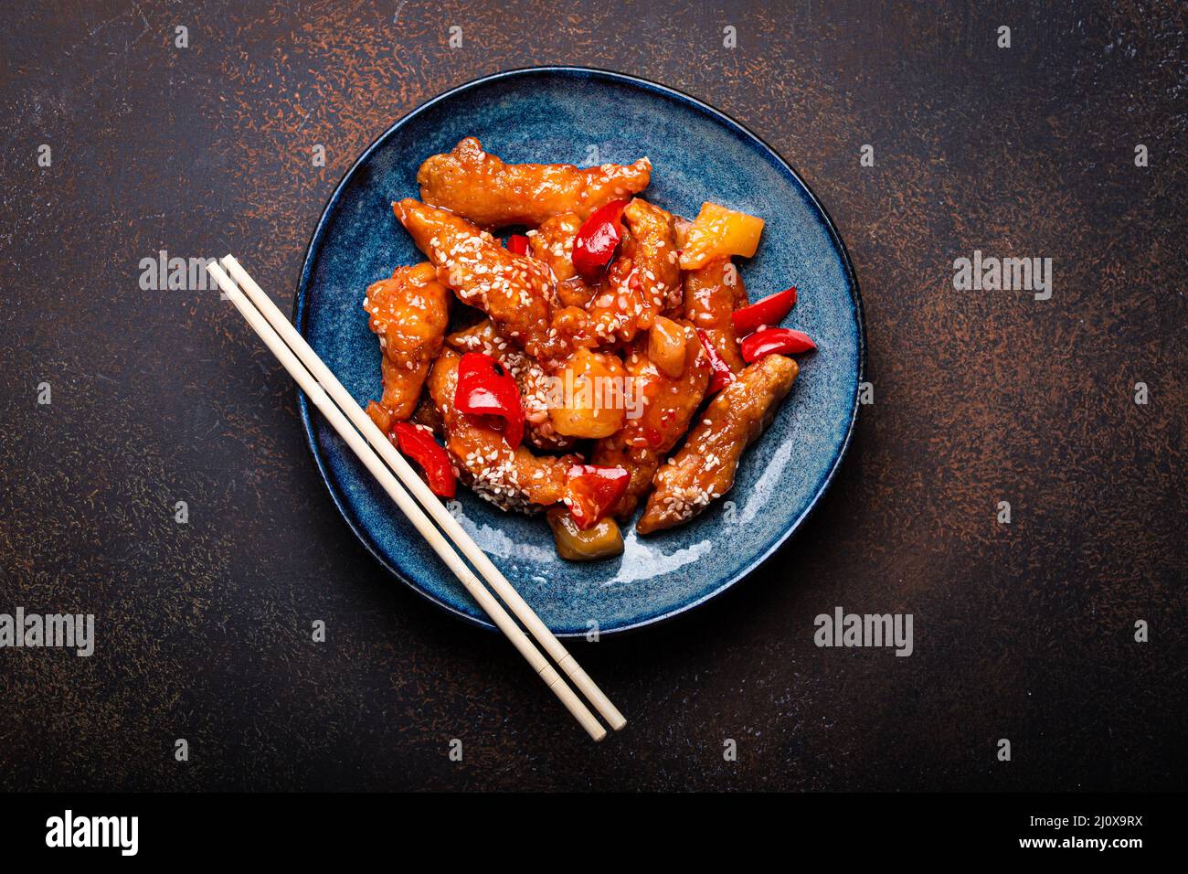 Chinesische traditionelle Wok-Gericht Schweiß-und saure frittierte Huhn mit Gemüse rühren-braten auf dem Teller Stockfoto