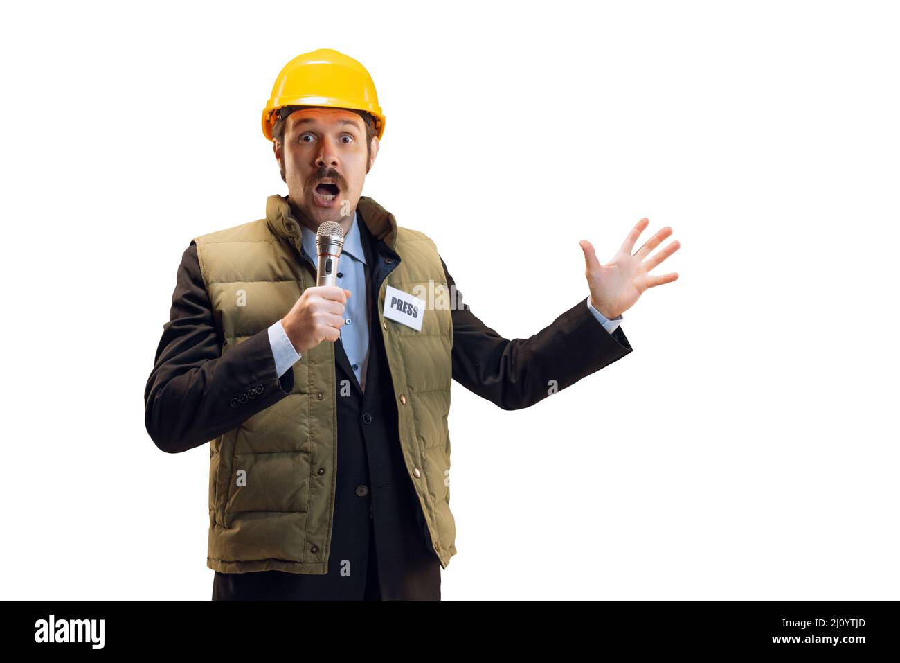 Porträt eines jungen Mannes im Helm, professioneller Kommentator, Journalist mit Mikrofon, isoliert auf weißem Hintergrund. Nachrichten, Emotionen, Job Stockfoto