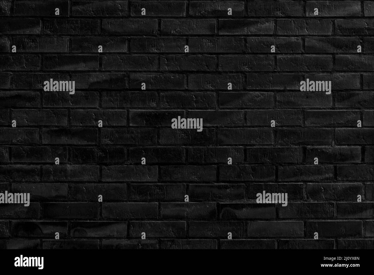 Der Hintergrund der alten schwarzen Backsteinmauer für Design-Interieur und verschiedene Szenen oder als Hintergrund für Video-Interviews. Stockfoto