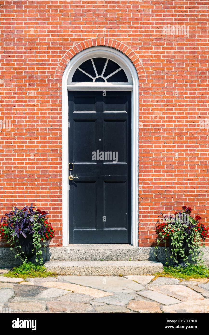 Blick auf ein Haus Front Red Door Surround mit Pflanzen und Blumen in Portsmouth NH, USA Stockfoto