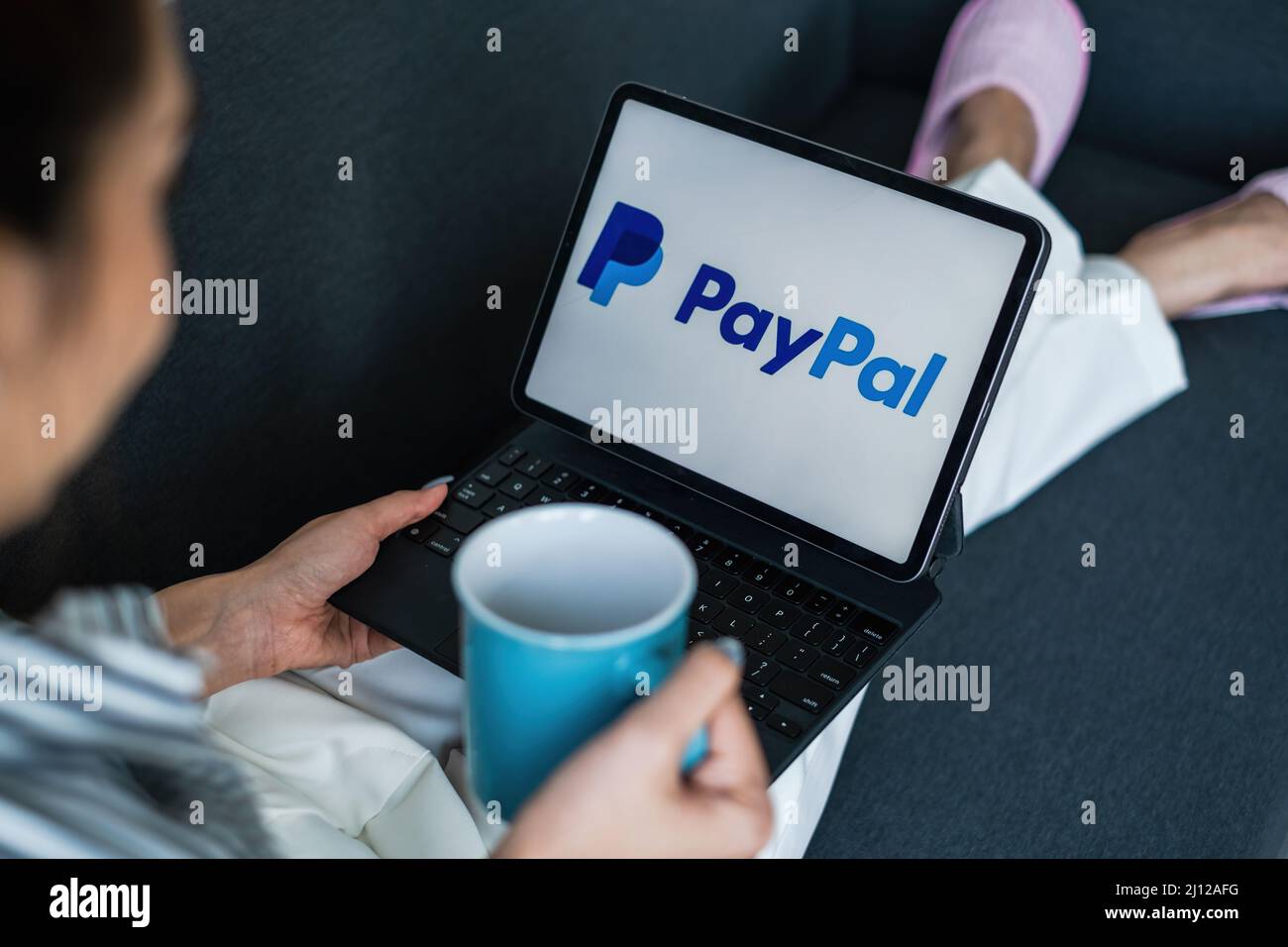 CHIANG MAI, THAILAND - MÄR 18 2021 : Frau mit iPad mit paypal-Logo auf dem Bildschirm. PayPal ist ein weltweites Online-Zahlungssystem und eines der am meisten Stockfoto