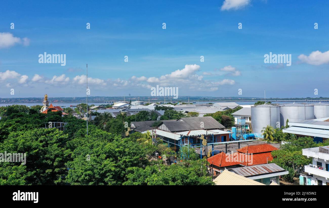 Hafen Benoa, Bali, Indonesien - Februar 26, 2019: Nahaufnahme von Pertmina Tankstelle auf Tanyung Benoa Halbinsel mit roten Dächern und baum laub Stockfoto