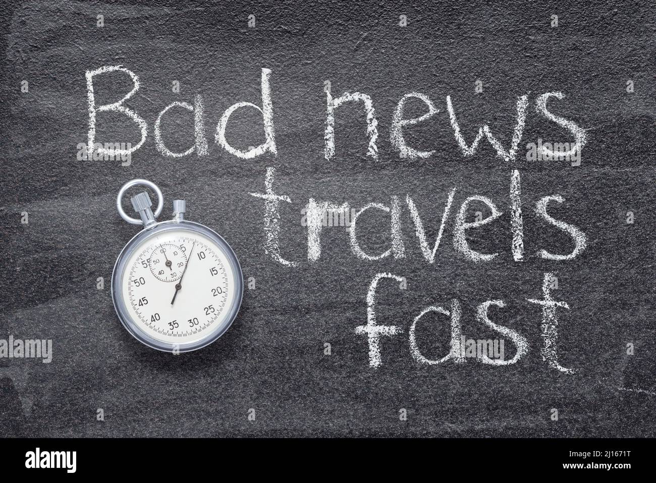 Schlechte Nachrichten reisen schnell - englisches Sprichwort auf Kreidetafel mit präziser Vintage-Stoppuhr geschrieben Stockfoto