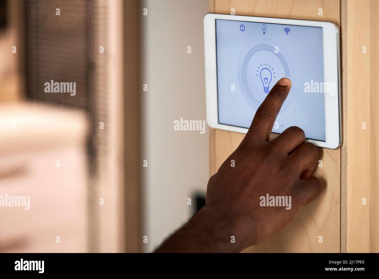 Man betreibt Beleuchtungssystem auf Tablet-PC zu Hause Stockfoto