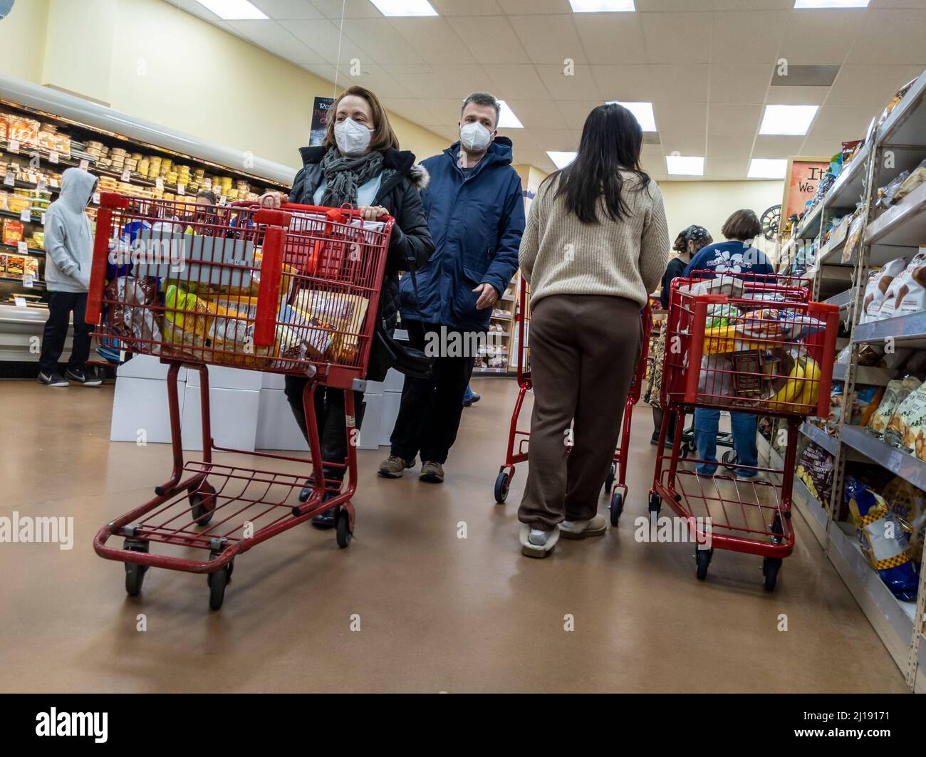 Kirkland, WA USA - ca. Februar 2022: Schräge Ansicht mehrerer Menschen, die in einem Trader Joe's Lebensmittelgeschäft einkaufen. Stockfoto