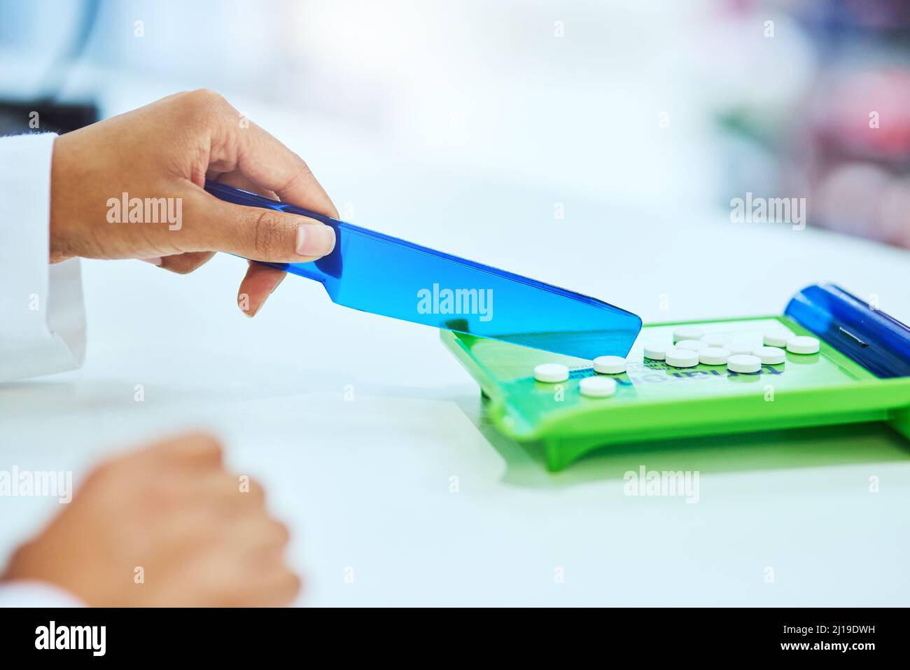 Sicherstellen, dass die Dosierung perfekt ist. Zugeschnittenes Bild einer nicht erkennbaren Apothekerin, die Medikamente in der Apotheke trennt. Stockfoto