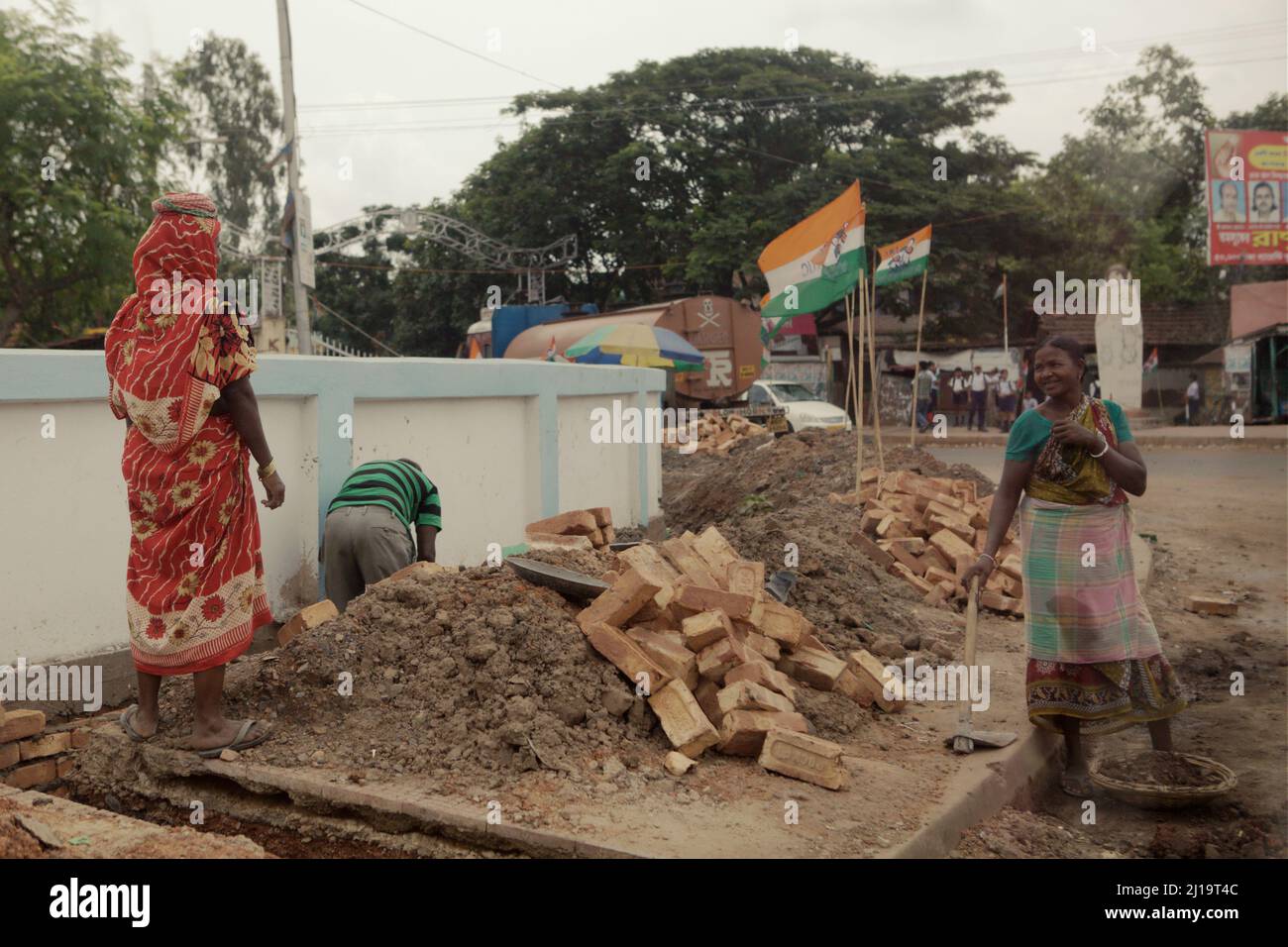Frauen, die in Handarbeit auf einer Baustelle am Straßenrand in Kolaghat, Purba Medinipur, Westbengalen, Indien, arbeiten. Stockfoto