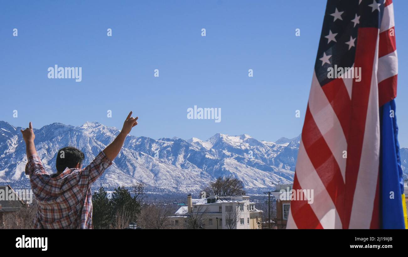 Mann, der bei einer Kundgebung die Waffen zur Unterstützung der Ukraine hochhebt Stockfoto