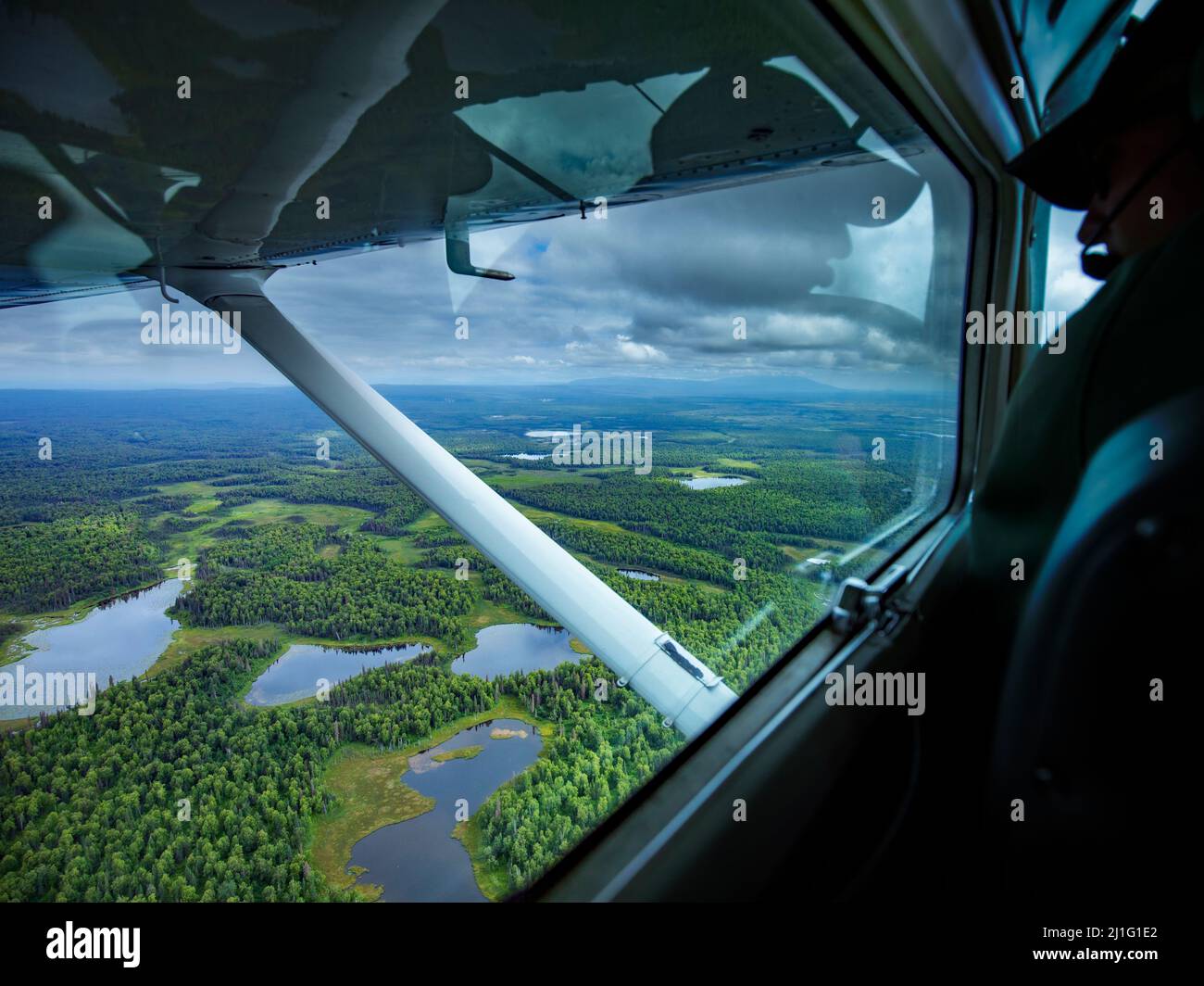 Beifahrer wunderschöne Aussicht vom Buschflugzeug, das über den wilden Alaska Wald und Seen fliegt Stockfoto